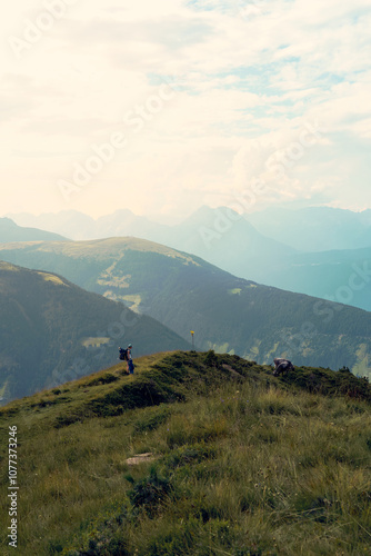 Scenic mountain landscape with hikers exploring the ridge during a serene afternoon in the Alps