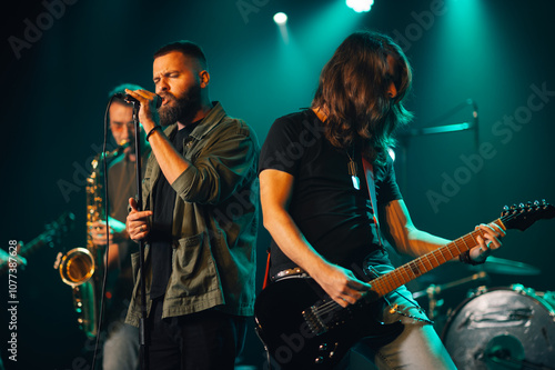 Fotografía Rock band performing live on stage with singer and guitarist