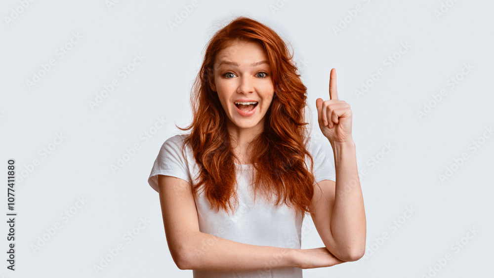 Great Idea. Excited Girl Pointing Finger Up Having Idea Eureka Moment Posing Over White Background. Studio Shot, Panorama Great Idea. Excited Girl Pointing Finger Up Having Idea Eureka Moment Posing Over White Background. Studio Shot, Panorama