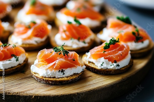 Appetizing salmon canapes on wooden board, close-up photo