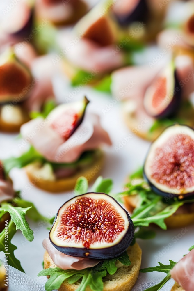 Gourmet fig appetizers on fresh arugula and crusty bread Gourmet fig appetizers on fresh arugula and crusty bread