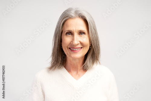 Beautiful, smiling, happy senior woman standing, posing isolated on white background