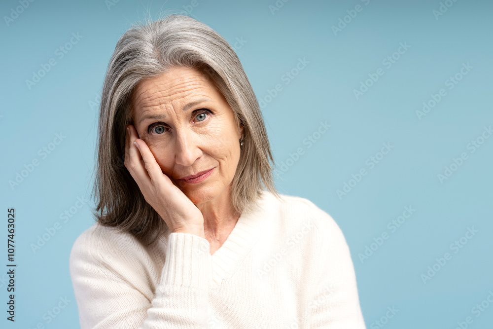 Portrait of pensive, tired, gray haired senior woman looking at camera, copy space Portrait of pensive, tired, gray haired senior woman looking at camera, copy space