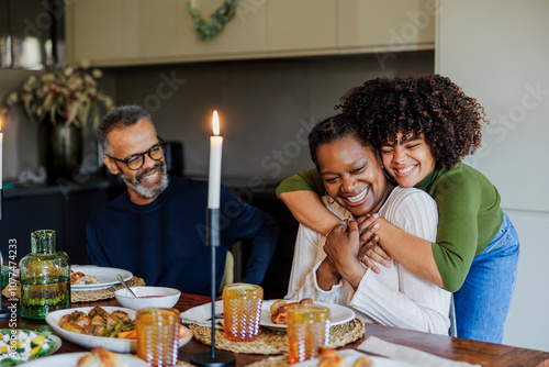Happy family celebrating thanksgiving day with hugs and smiles