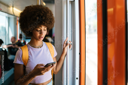 Woman Checking Phone on Tram photo