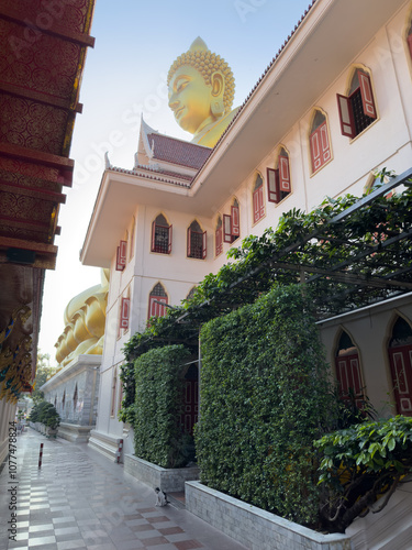 A building with a large statue of Buddha on the roof photo