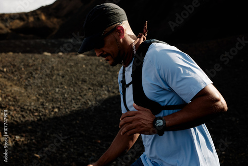 A trail runner stretches before beginning his hiking workout photo