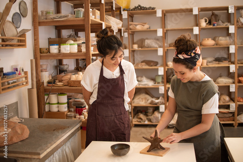 Two friends taking a sculpture class together