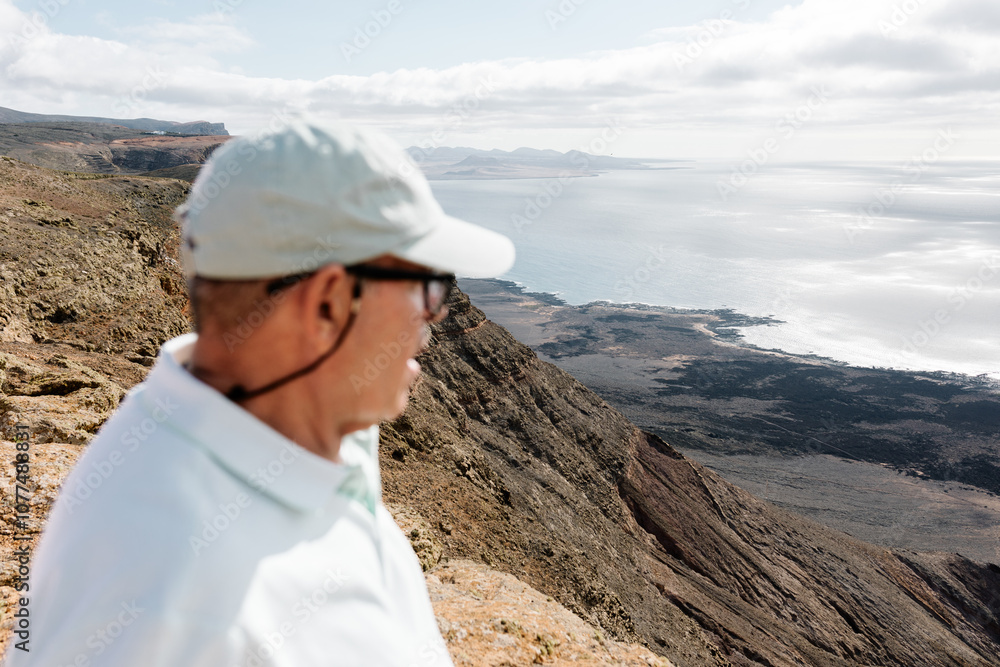 Medium shot of an elderly tourist enjoying the view at Mirador del Rio Medium shot of an elderly tourist enjoying the view at Mirador del Rio