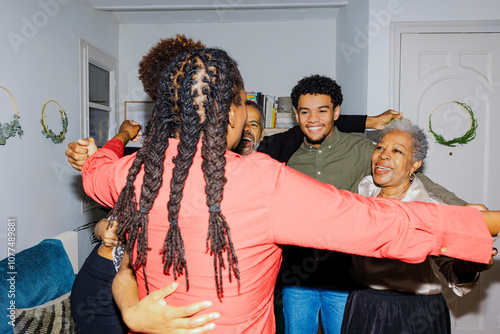 Happy multi generational family hugging at home photo