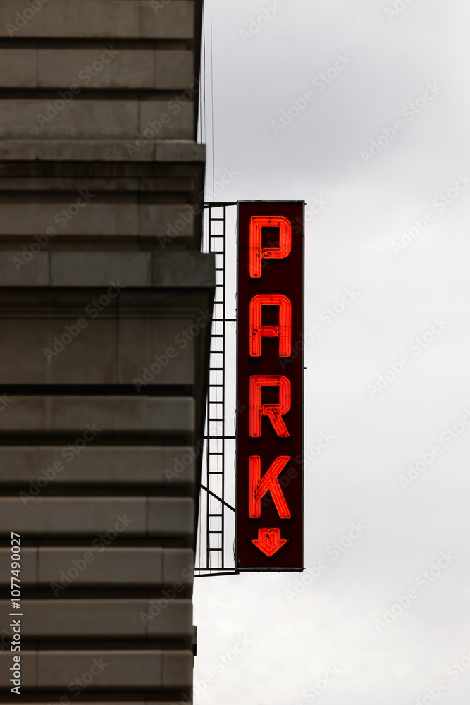 Iconic red neon parking sign in New York City on a cloudy day Iconic red neon parking sign in New York City on a cloudy day