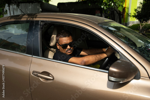 Fashionable Indian man inside a car photo