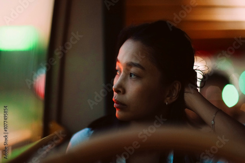 young girl looking out the bus window photo