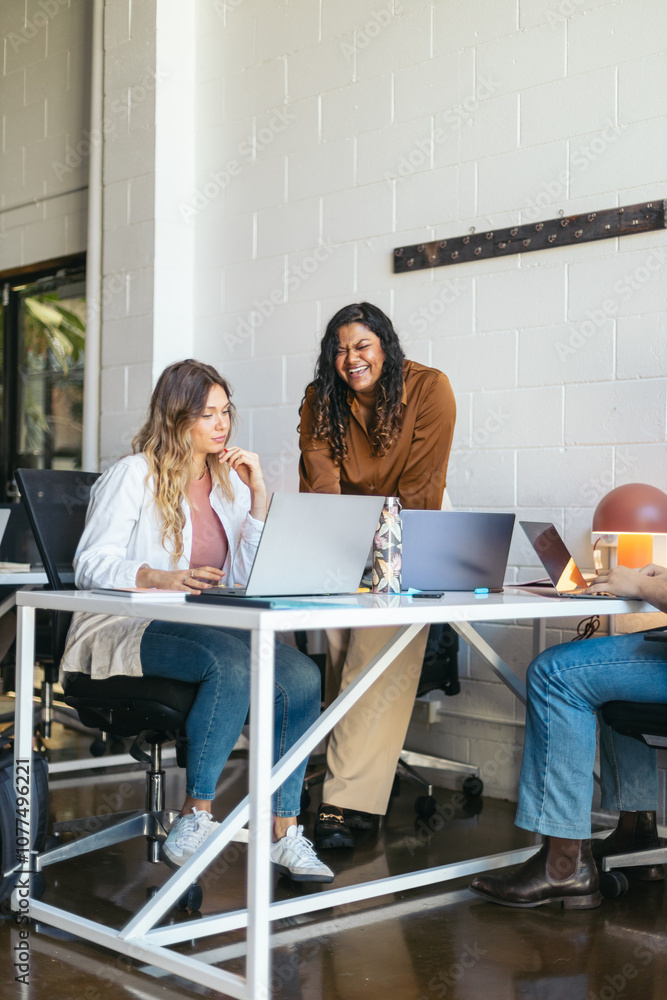 Coworkers sharing ideas in a coworking space. Coworkers sharing ideas in a coworking space.