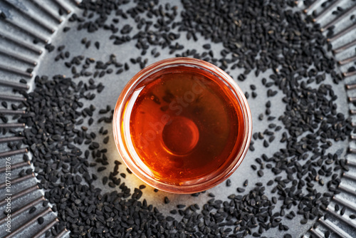 Black cumin or Nigella oil and seeds photo