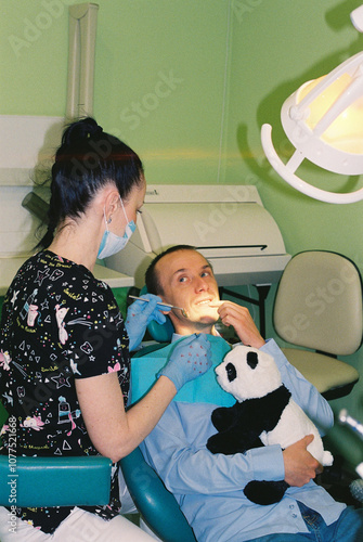 Patient tells the doctor about the problem with teeth. photo