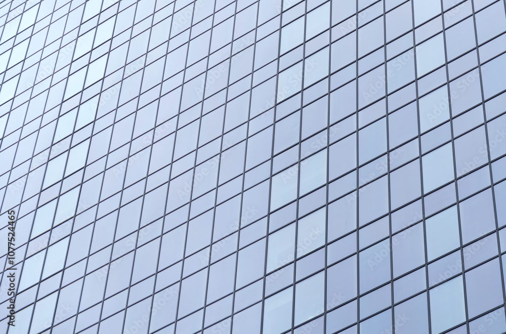 Modern glass facade reflecting the sky on a contemporary building downtown Modern glass facade reflecting the sky on a contemporary building downtown