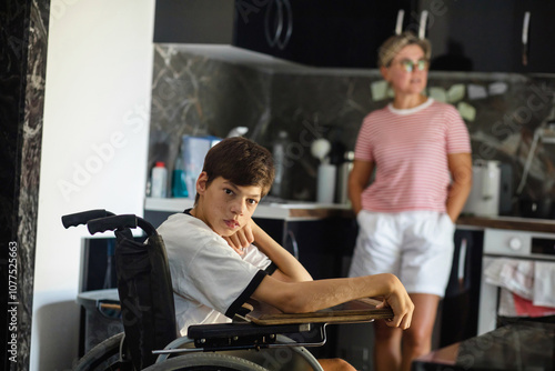 Disabled child and his mother in the kitchen