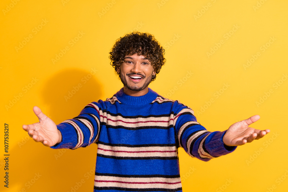 Photo portrait of pretty young male stretch hands want hug wear trendy blue striped outfit isolated on yellow color background Photo portrait of pretty young male stretch hands want hug wear trendy blue striped outfit isolated on yellow color background
