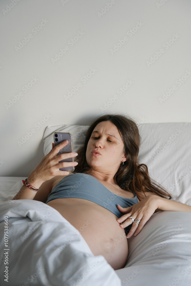 Pregnant Woman in Bed Distracted by Uncomfortable Body Sensations Pregnant Woman in Bed Distracted by Uncomfortable Body Sensations
