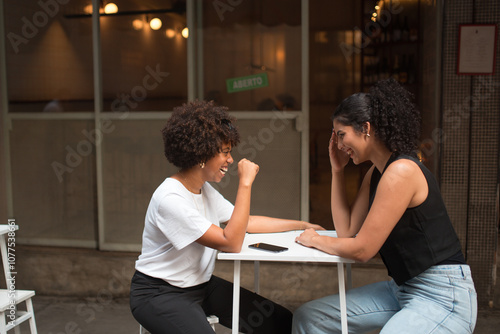 Two Young Friends Talking Outdoors photo