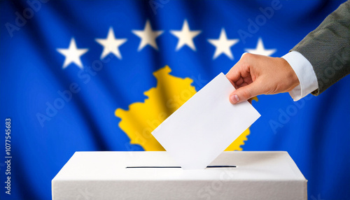 Detail of a hand inserting a ballot into a ballot box with the flag of Kosovo out of focus. photo