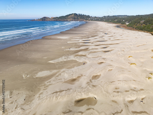 Bright sunlight shines on Agate Beach situated along the Oregon Coast Highway in the town of Newport. The beautiful beach is named after its abundance of iron oxide-colored agates found there. photo