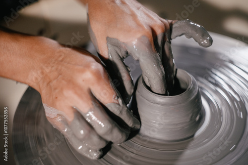 Creating a pottery piece on a wheel at an artisan studio photo