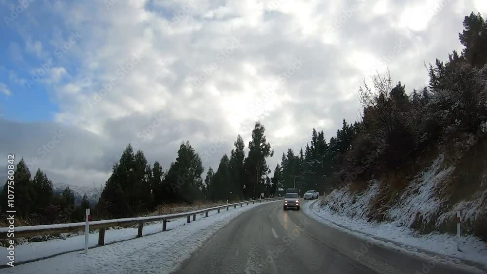 Scenic winter drive along Crown Range Road between Queenstown and Wanaka, Cardrona Oatgo New Zealand, Snow-covered mountains and winding roads serene alpine landscape Scenic winter drive along Crown Range Road between Queenstown and Wanaka, Cardrona Oatgo New Zealand, Snow-covered mountains and winding roads serene alpine landscape