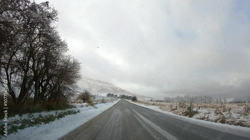 Scenic winter drive along Crown Range Road between Queenstown and Wanaka, Cardrona Oatgo New Zealand, Snow-covered mountains and winding roads serene alpine landscape Scenic winter drive along Crown Range Road between Queenstown and Wanaka, Cardrona Oatgo New Zealand, Snow-covered mountains and winding roads serene alpine landscape