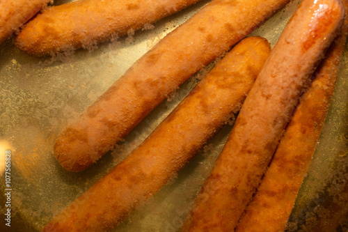 Close-up of hot dogs boiling in water 