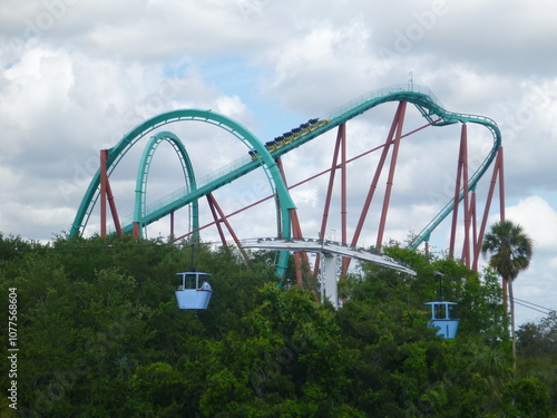 Outdoor theme park in Florida, USA with rollercoaster, cable car and greenery