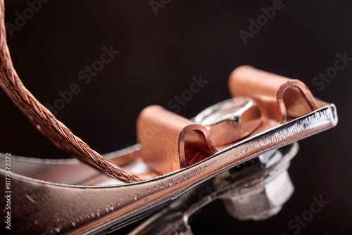 Close-up view of grounding clamp parts with copper contacts from a welding inverter machine, highlighting precise details of industrial design. photo