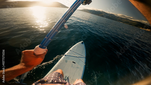 Paddling on SUP board at sunset