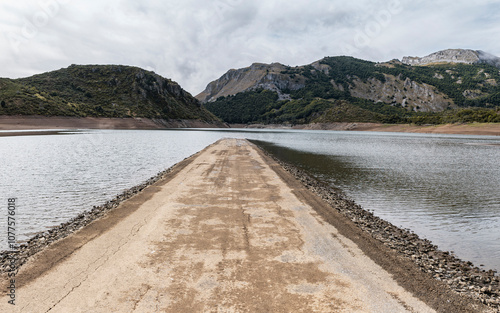 Rugged causeway across a mountain reservoir photo