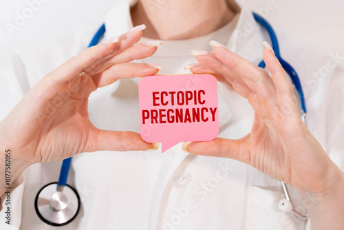 Ectopic Pregnancy. The word is written on a slip of colored paper. photo