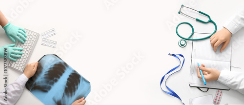 Hands of doctors with computer keyboard, x-ray scan and notebook on white background. Banner for design photo