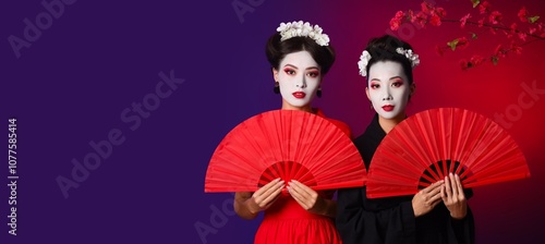 Beautiful young geishas hol...