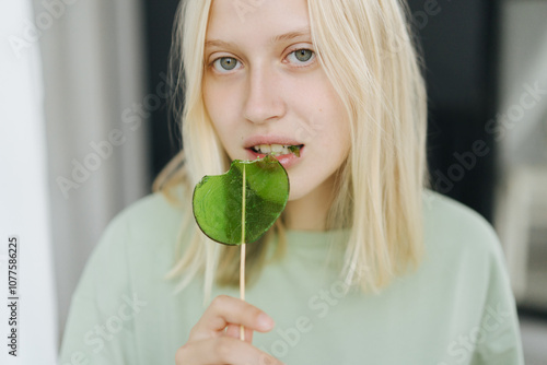 Woman with green lollipop photo