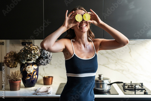 Playful real moment of woman with limes over her eyes photo