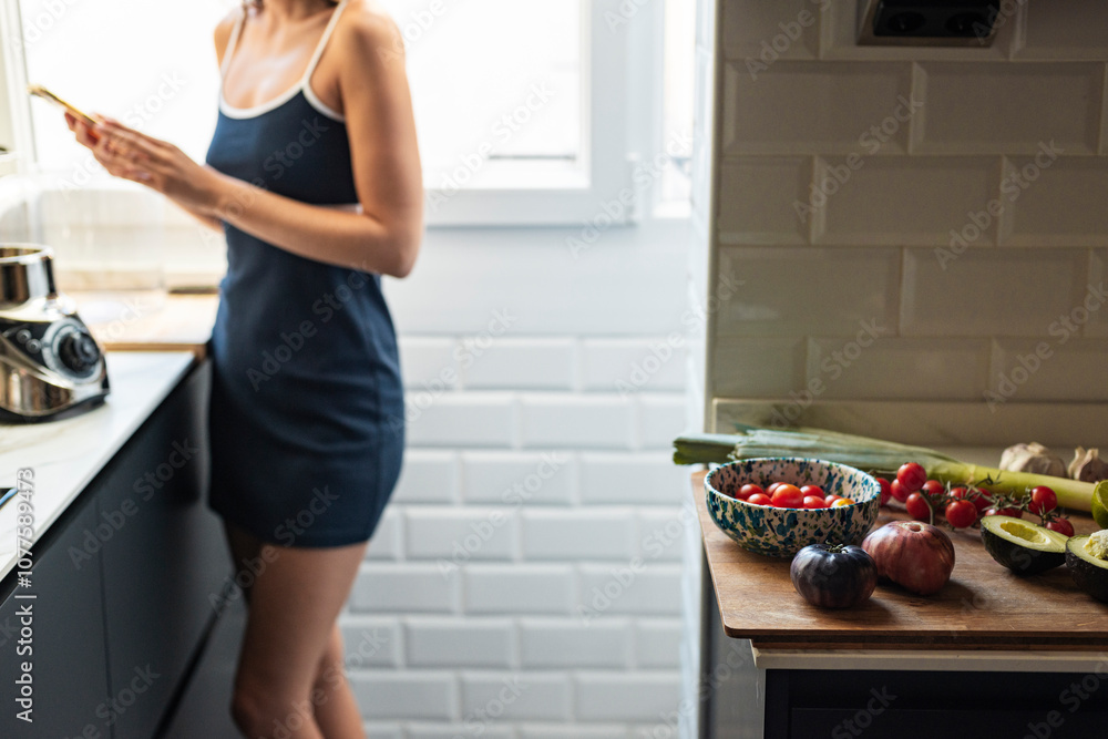Female Cook Using Smartphone in Kitchen Female Cook Using Smartphone in Kitchen