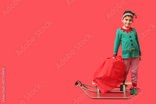 Cute little elf with sled a...