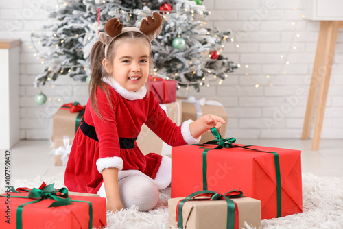 Cute little girl in Santa c...