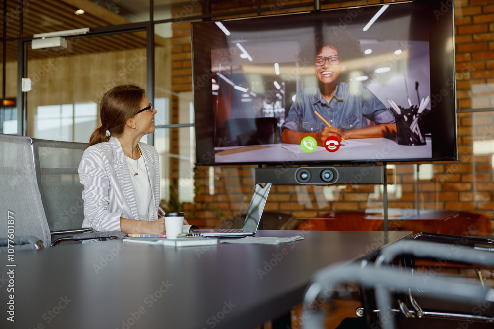 A video call taking place in a contemporary workspace that highlights collaboration and the use of advanced technology A video call taking place in a contemporary workspace that highlights collaboration and the use of advanced technology