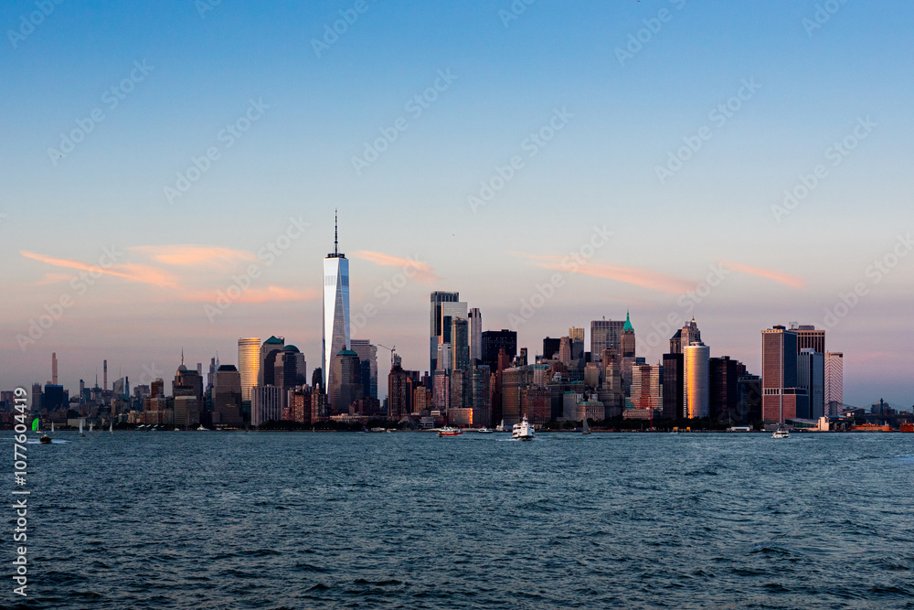Manhattan's majestic skyscrapers bathed in glowing colors of sunset Manhattan's majestic skyscrapers bathed in glowing colors of sunset