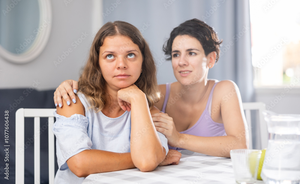 Please forgive me. Angry woman pouting, ignoring apologies of her female partner who hugging her and begging for forgiveness after having quarrel Please forgive me. Angry woman pouting, ignoring apologies of her female partner who hugging her and begging for forgiveness after having quarrel