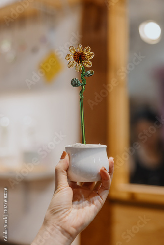 Hand Holding Glass Flower in Pot photo