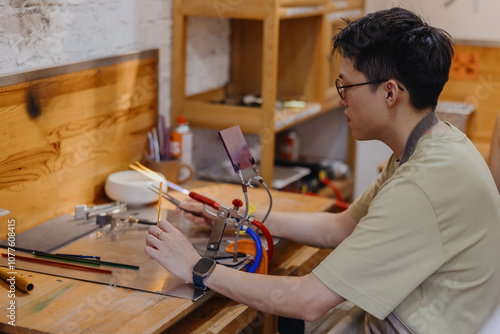 Glass Artist Working in Studio photo