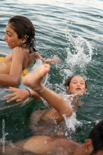 A girl falling back into the water with her family around her. photo