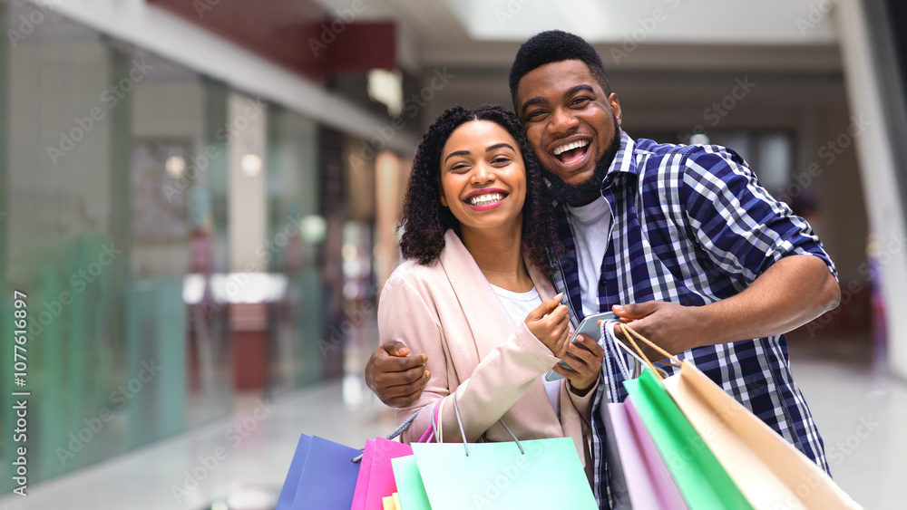 Seasonal Sales. Happy African Spouses Posing In Mall With Lots Of Shopping Bags Seasonal Sales. Happy African Spouses Posing In Mall With Lots Of Shopping Bags